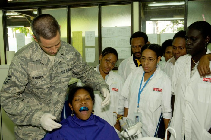 Unrecognizable crop dentist holding instruments in hands while working ...